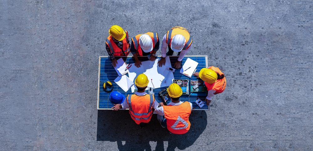five construction workers collaborating seen from above